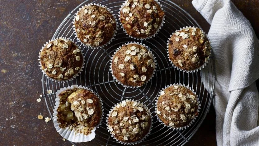 Freshly baked Apple Banana Muffins on a cooling rack.