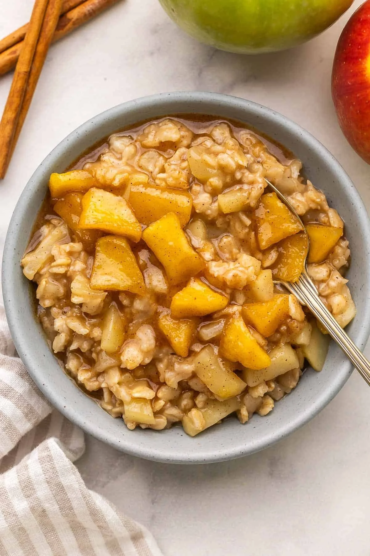 Bowl of Apple Cinnamon Oatmeal topped with diced apples and cinnamon