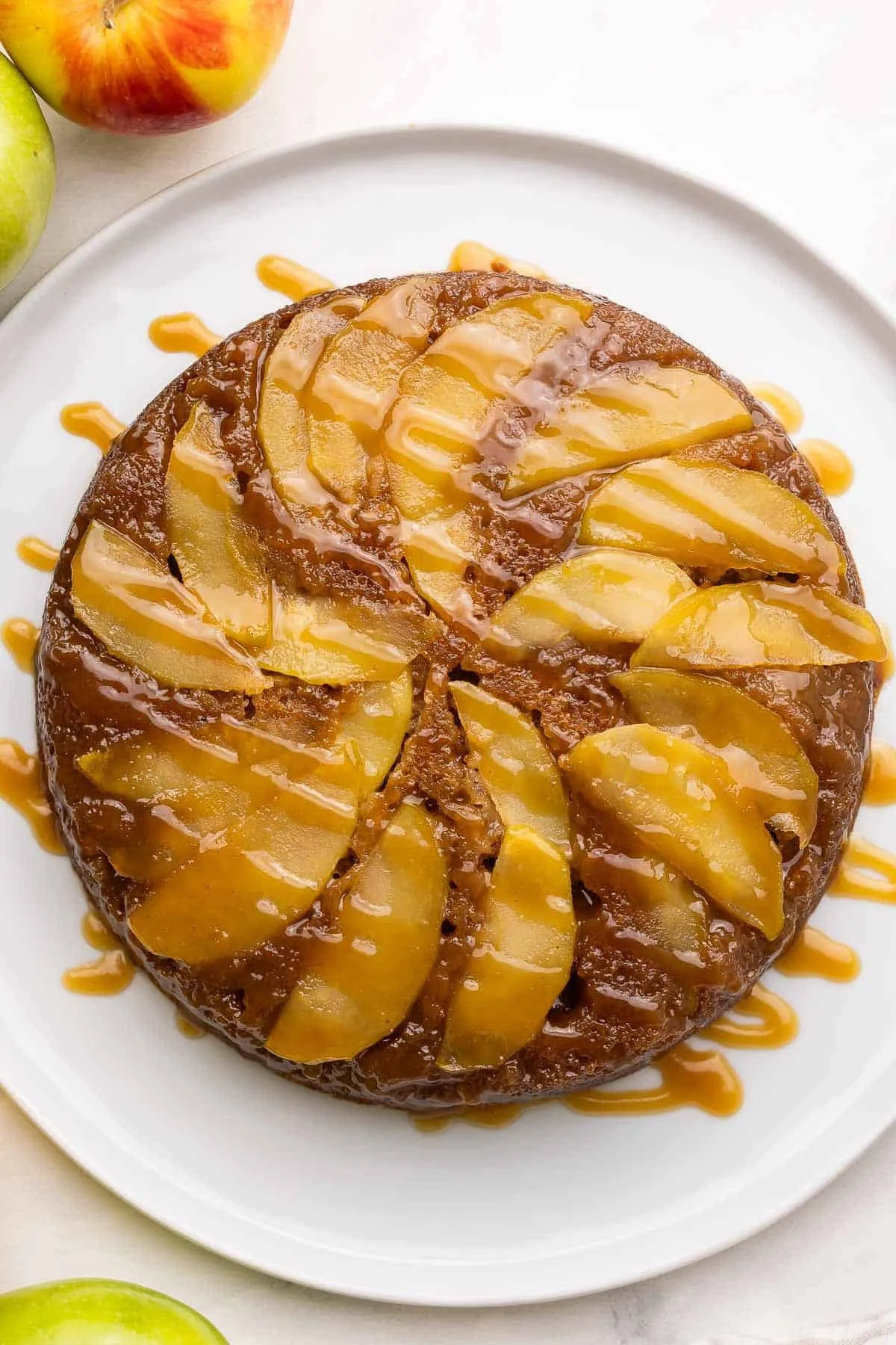 Slice of homemade apple upside down cake with caramelized apples on top.