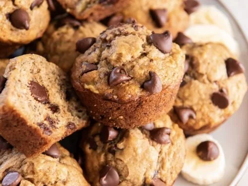 Freshly baked Banana Chocolate Chip Muffins on a cooling rack