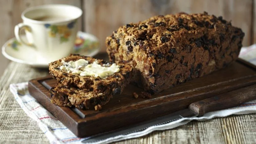 Freshly baked Bara Brith, a traditional Welsh speckled bread with fruits.