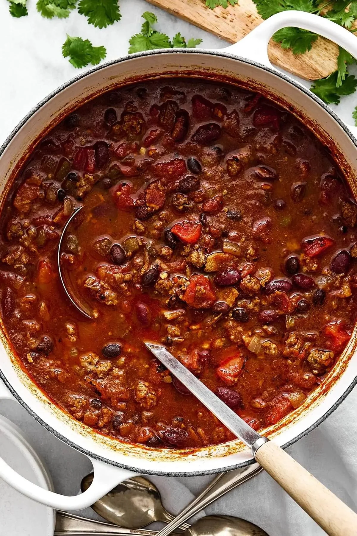 A bowl of the best ever chili topped with cheese and green onions.