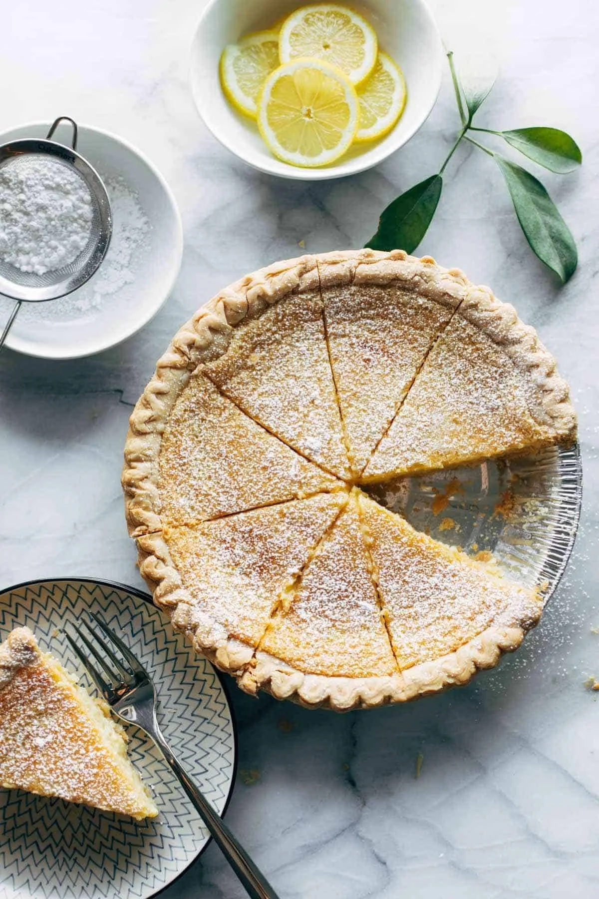 Delicious Blender Lemon Pie served with fresh lemon slices and whipped cream