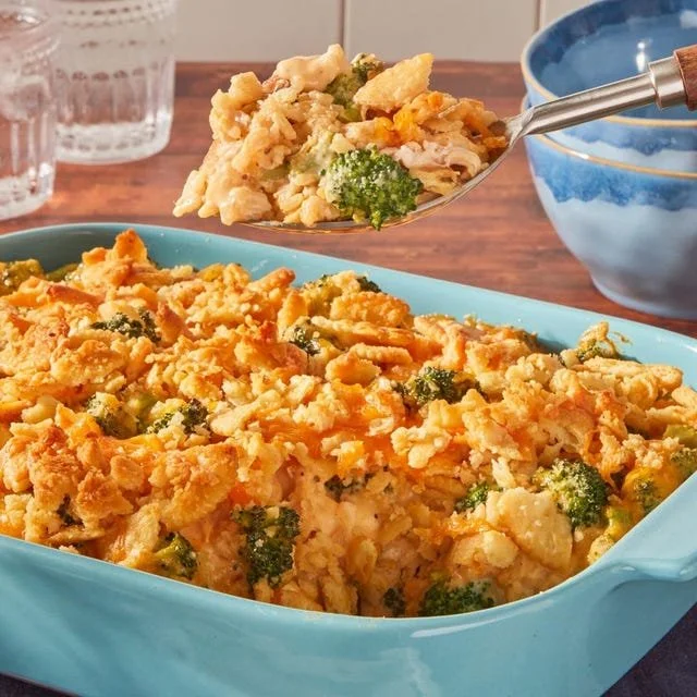 Delicious broccoli chicken casserole served in a baking dish with melted cheese on top.