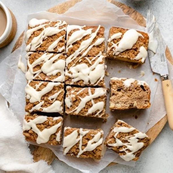 Slice of brown butter apple coffee cake with fresh apple slices on top