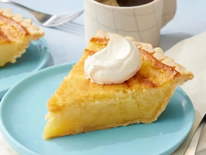 Delicious slice of buttermilk pie on a rustic wooden table