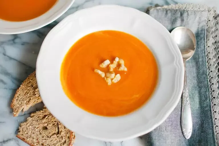 Creamy butternut squash soup in a bowl with garnishes