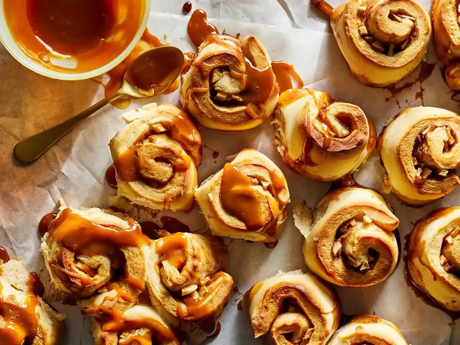 Delicious caramel apple cinnamon rolls topped with caramel drizzle