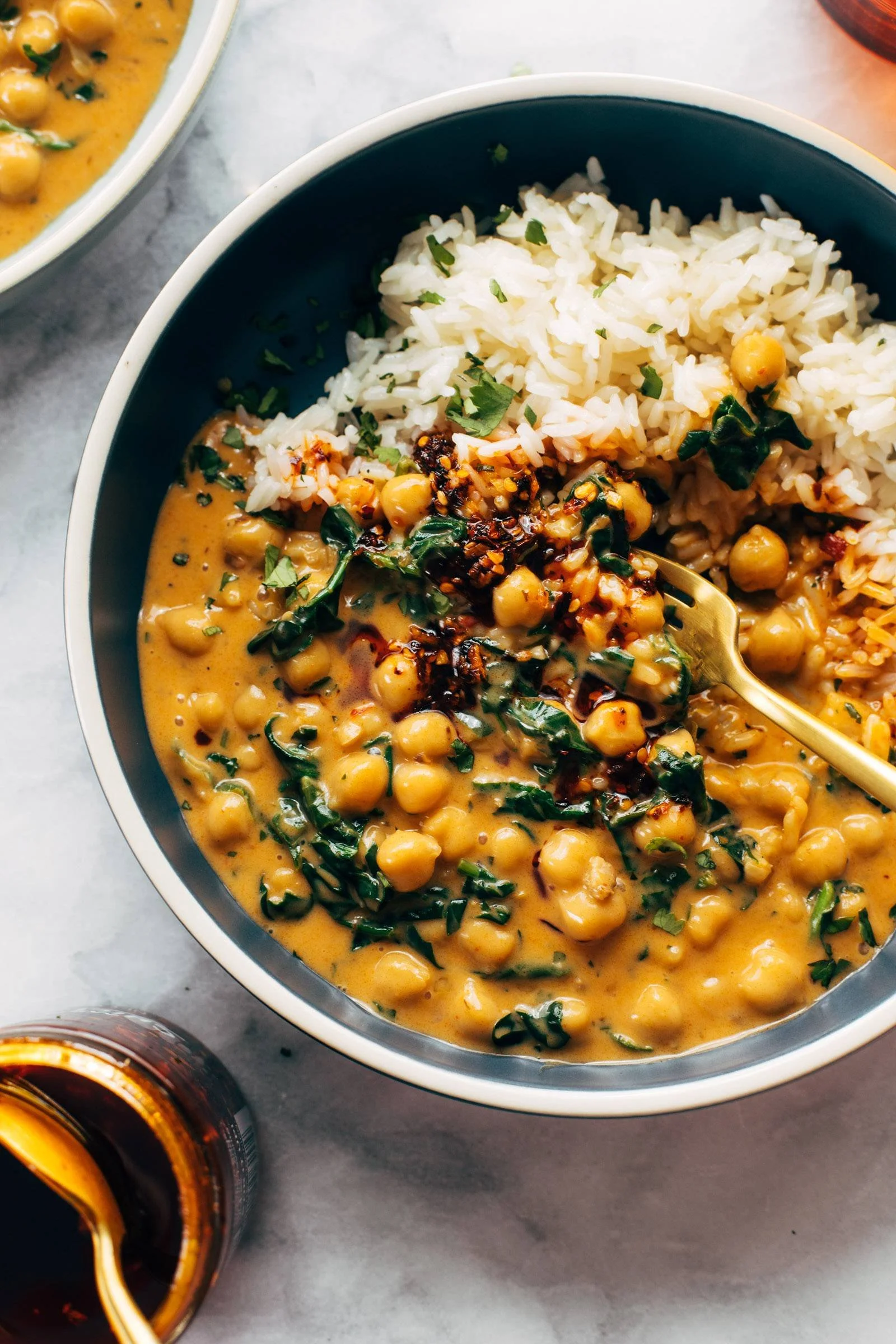 Delicious chickpea curry garnished with fresh herbs in a bowl