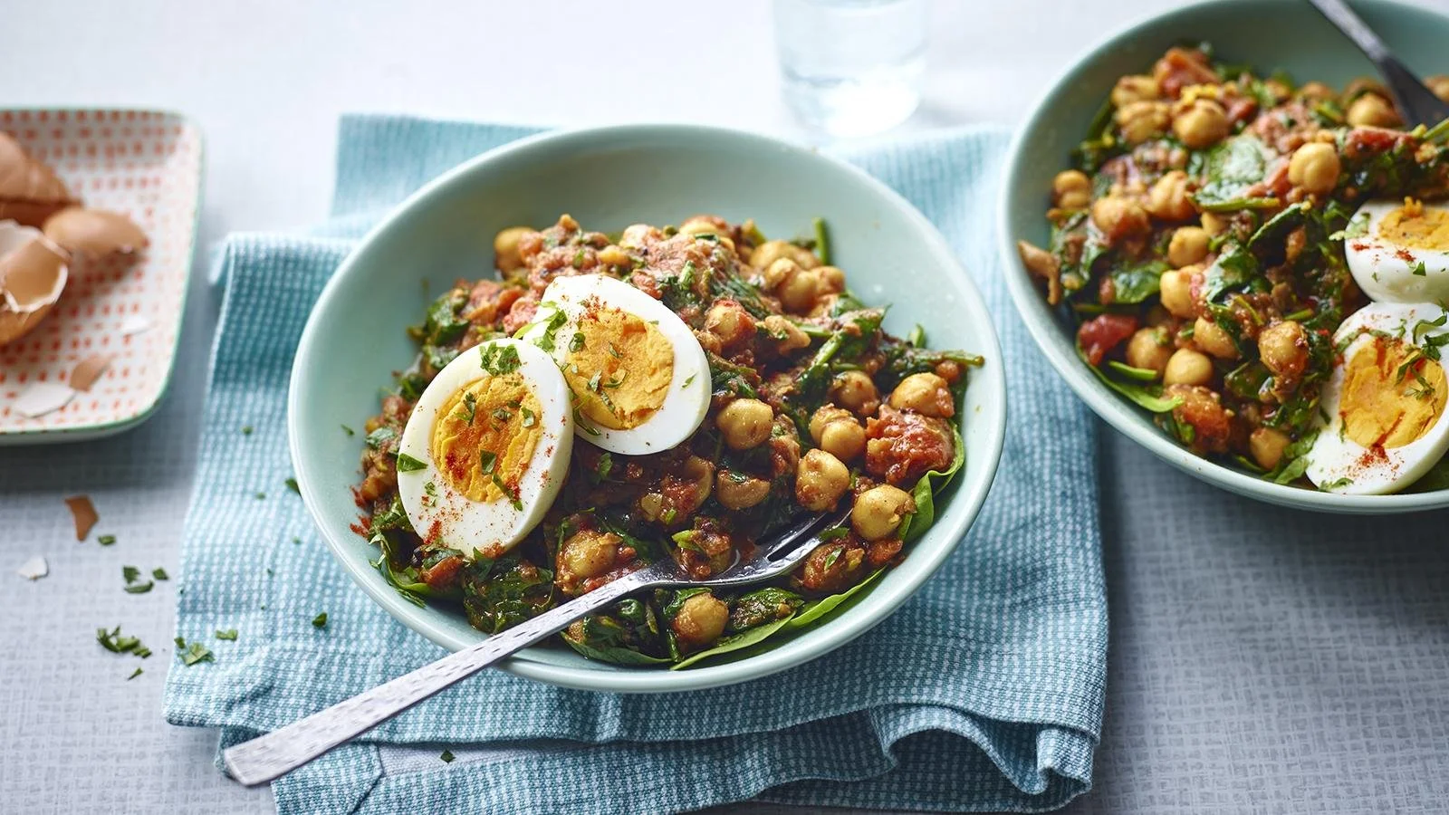 Delicious chickpea, spinach, and egg curry served in a bowl.