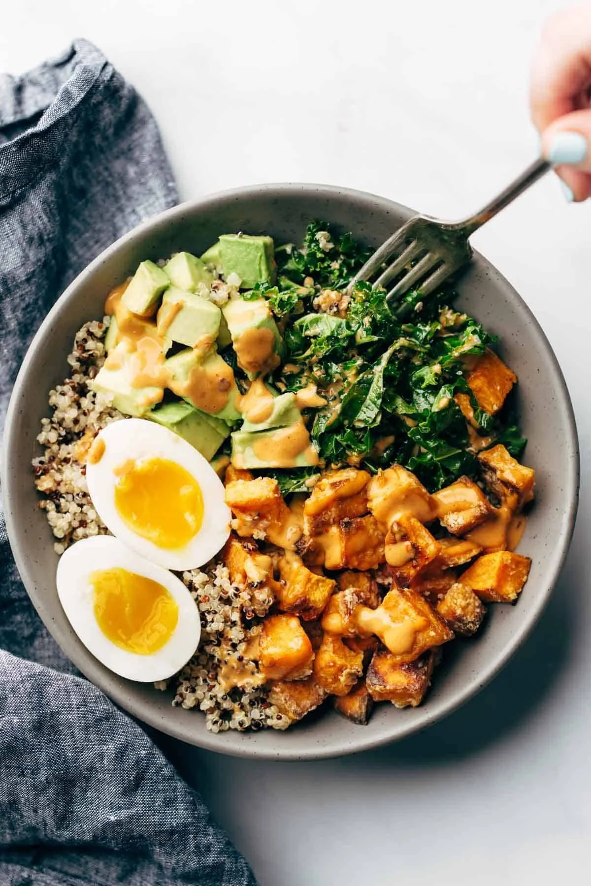 A colorful Chipotle Tahini Bowl with fresh veggies and tahini sauce
