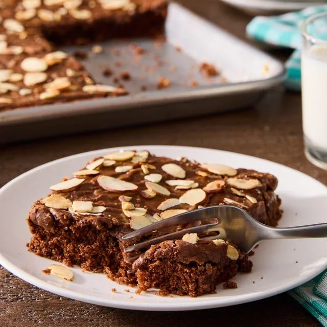 Delicious Chocolate Almond Sheet Cake topped with chocolate frosting and almonds