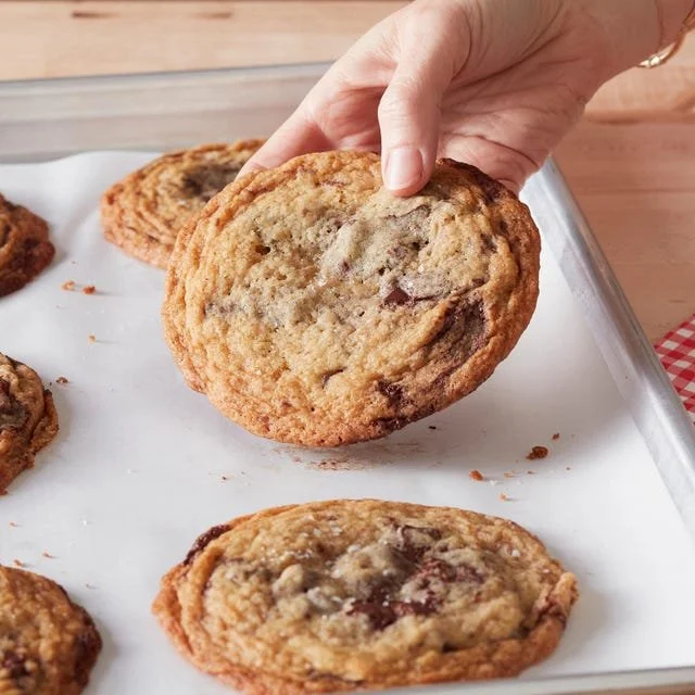 Freshly baked chocolate chip cookies on a cooling rack