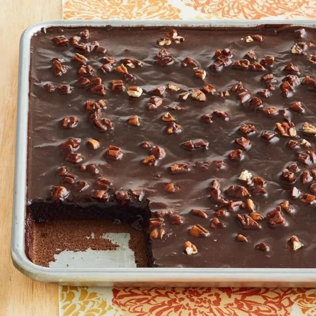 Delicious Chocolate Sheet Cake with Pecan Icing on a rustic wooden table