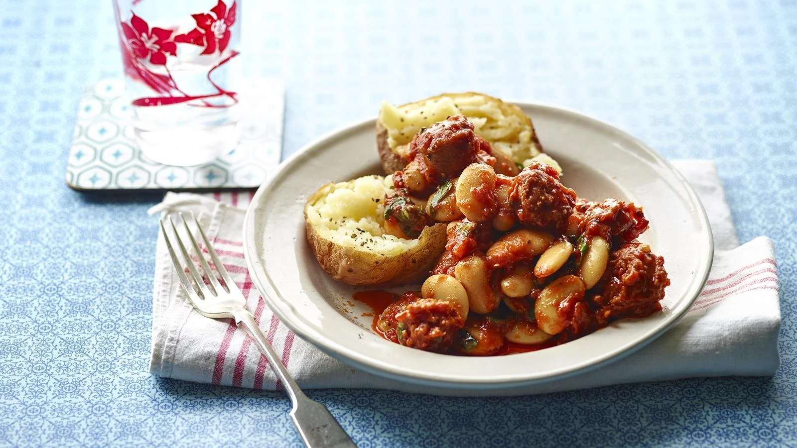 Baked potatoes topped with chorizo and butterbean mixture