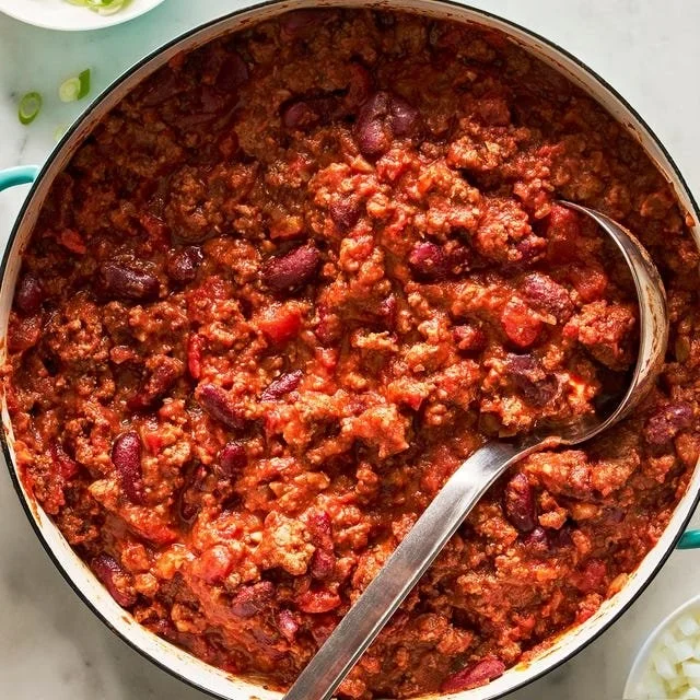 Bowl of classic chili topped with cheese and herbs