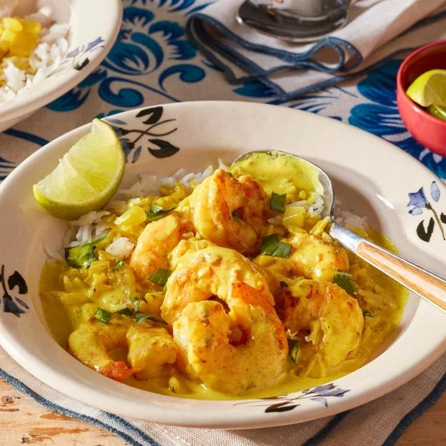 Bowl of delicious coconut shrimp curry garnished with fresh cilantro