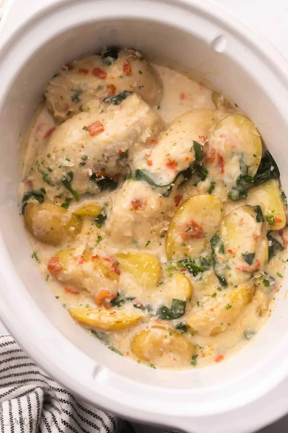 Creamy Italian crockpot chicken served with potatoes in a bowl