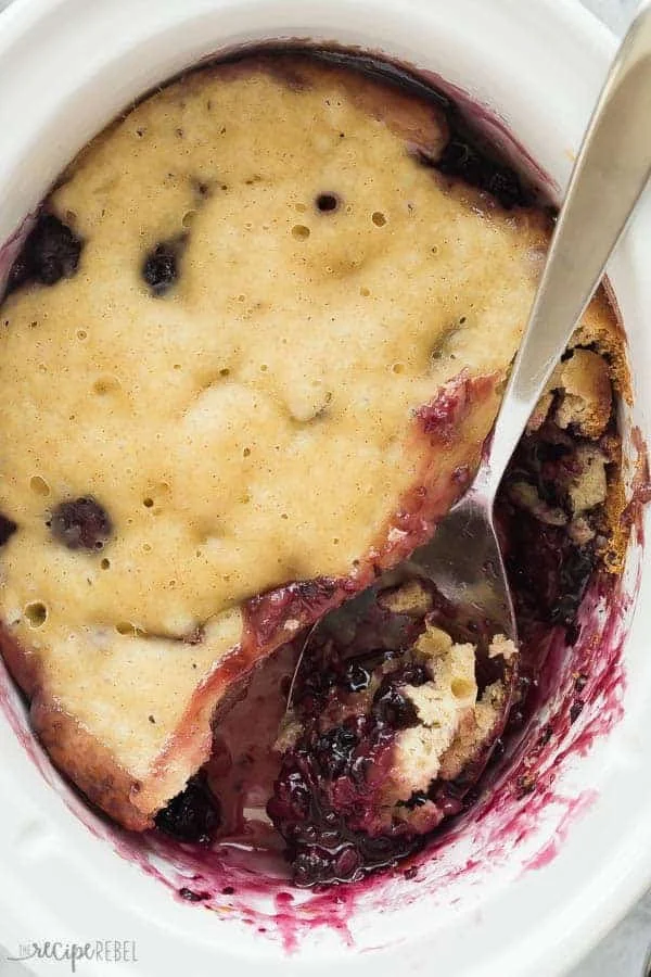Crockpot Blackberry Cobbler served in a bowl with fresh blackberries on top