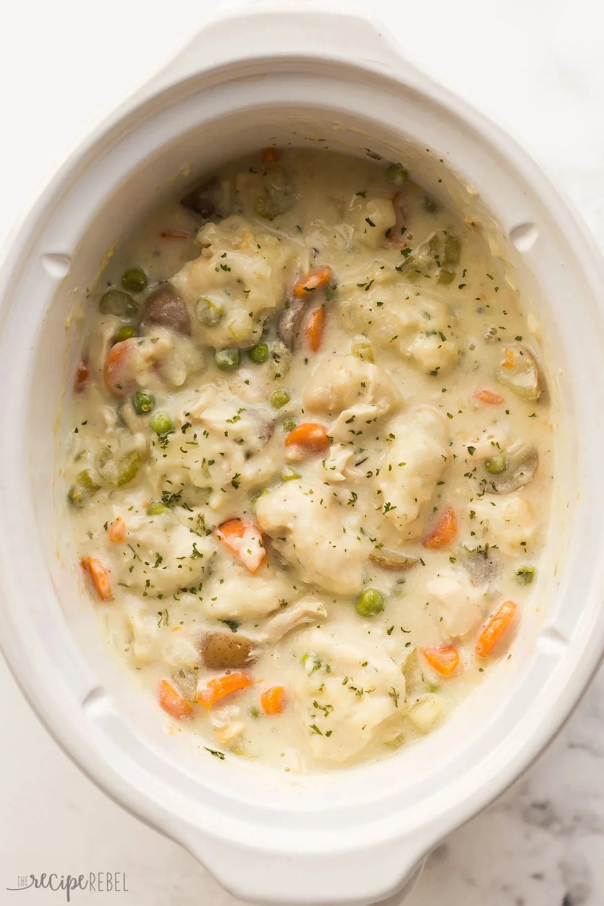 Crockpot Chicken and Dumplings served in a bowl, showcasing tender chicken and fluffy dumplings.