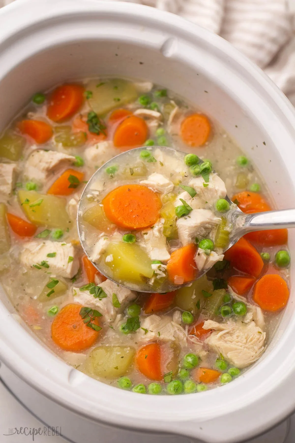 Delicious Crockpot Chicken Stew served in a bowl with fresh herbs