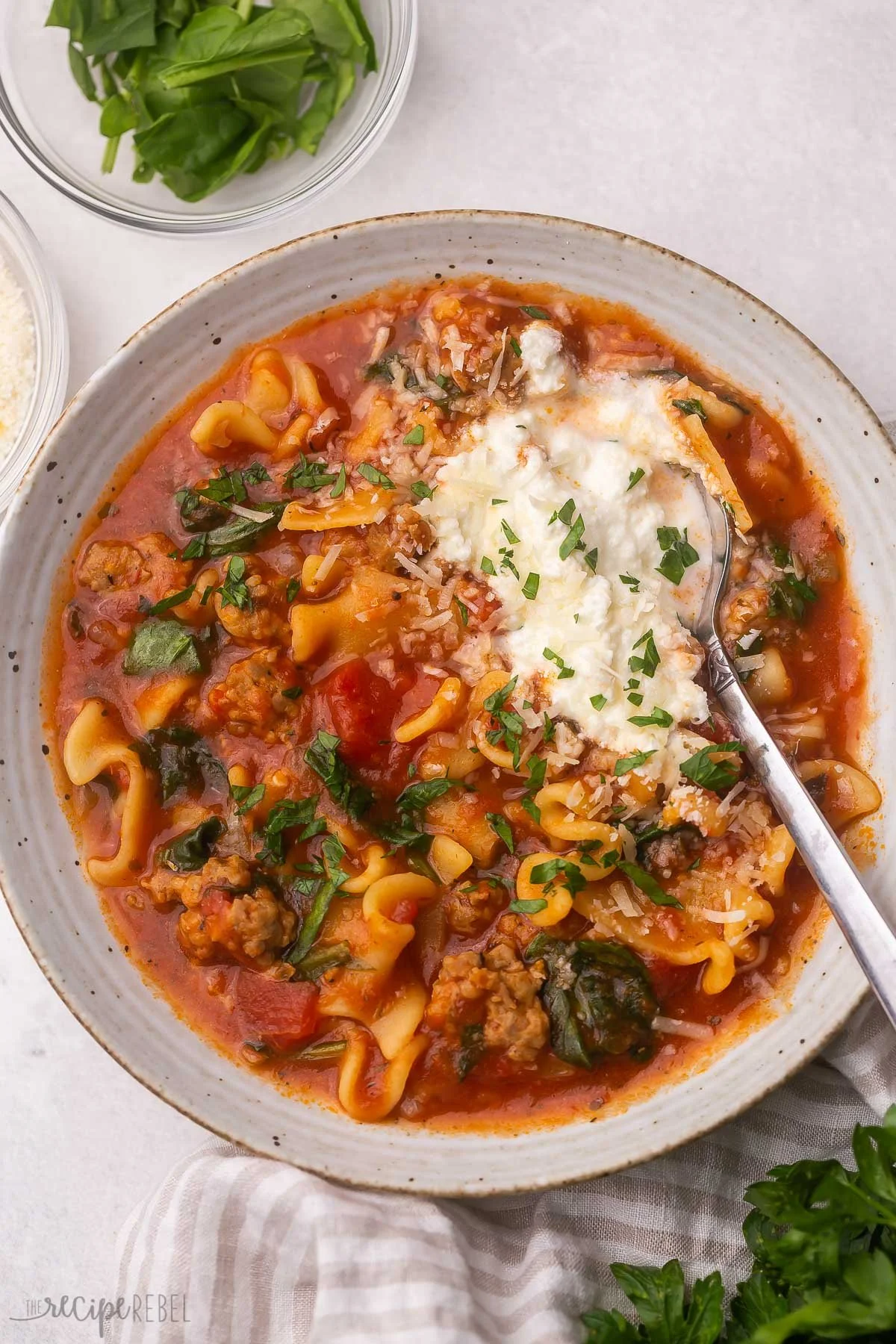 Delicious bowl of Crockpot Lasagna Soup garnished with herbs and cheese