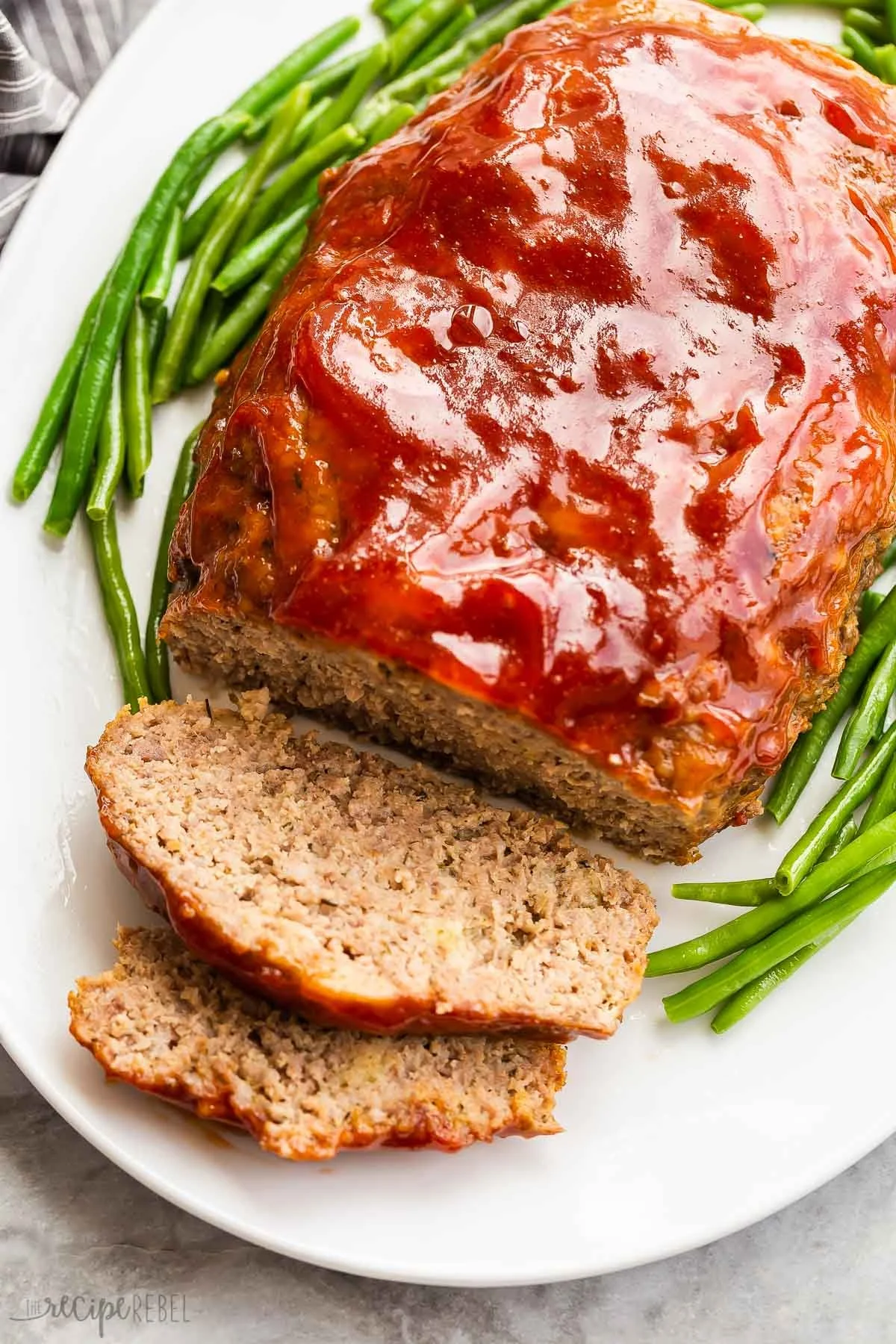 Deliciously cooked Crockpot Meatloaf served with garnishes.