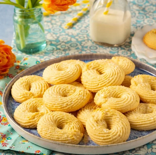 Delicious Danish Butter Cookies served on a plate with a cup of tea