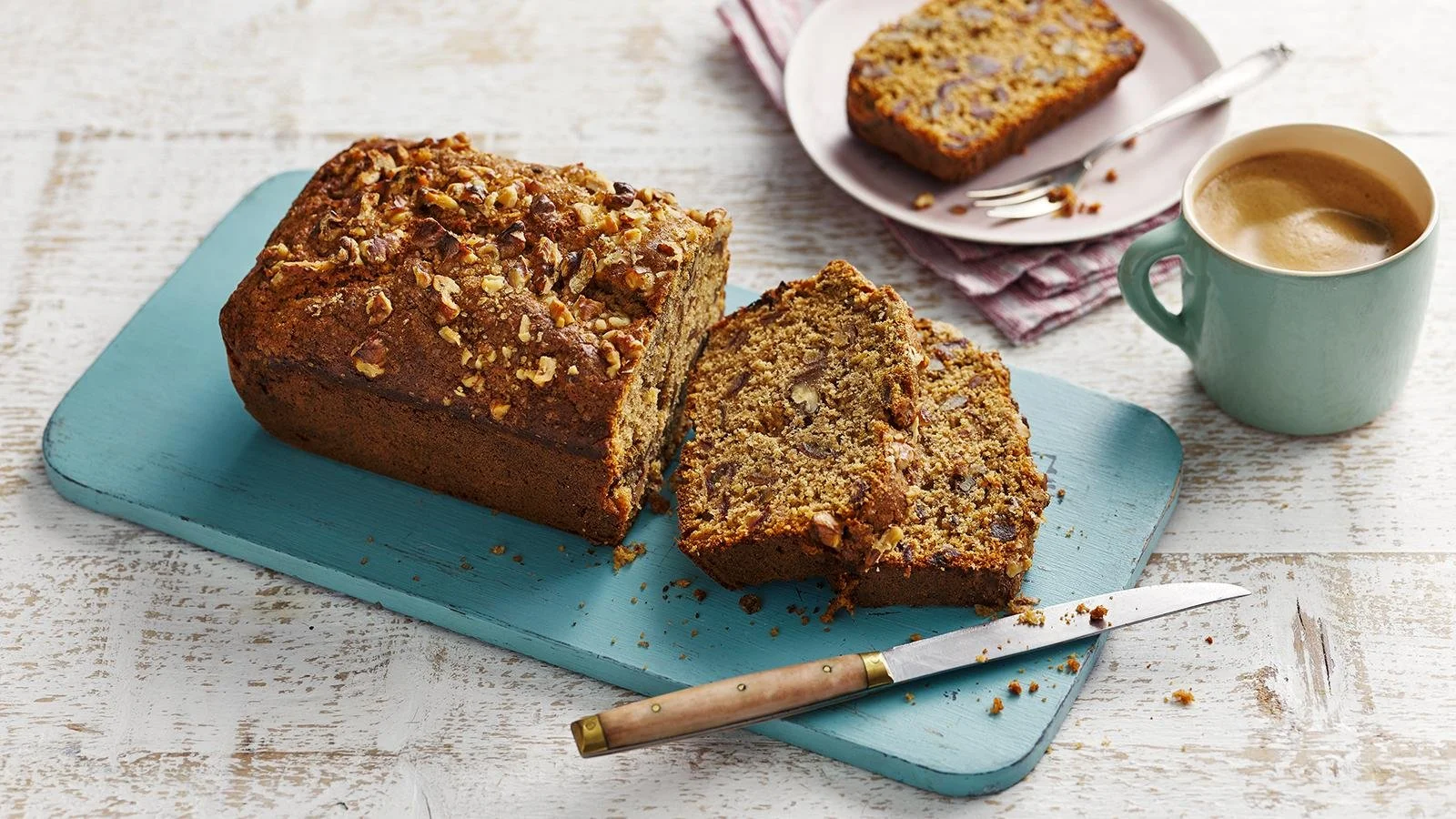 Homemade Date and Walnut Cake slice with nuts on a plate