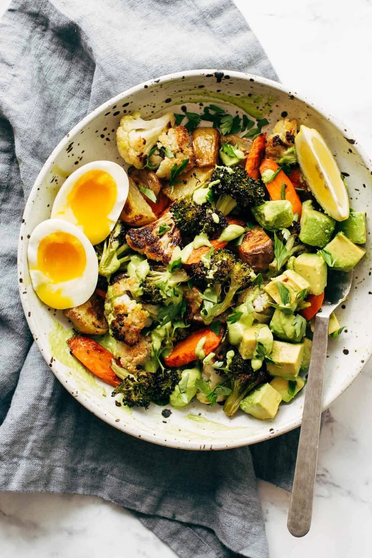 Deliciously roasted vegetables drizzled with creamy green tahini sauce