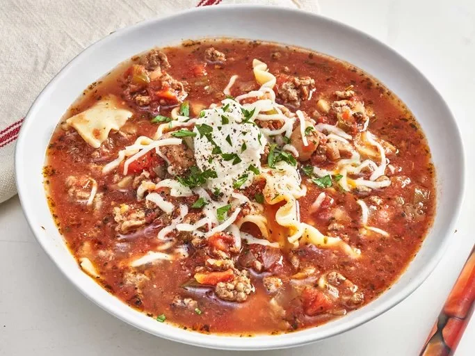 Bowl of Easy Slow Cooker Lasagna Soup garnished with herbs and cheese