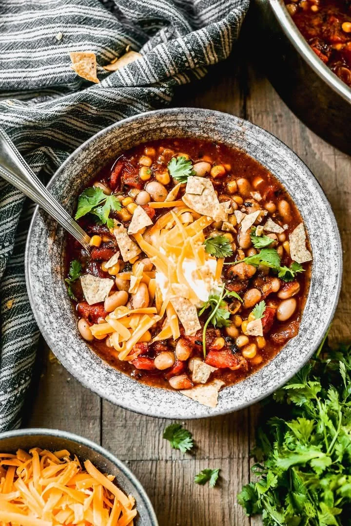 Bowl of easy taco soup garnished with cheese and cilantro