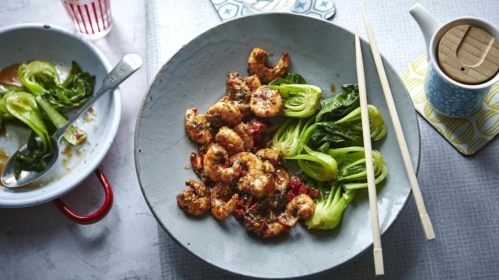 Plate of Firecracker Prawns served with vibrant stir-fried greens