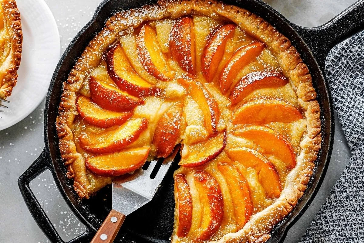 French peach tart topped with almond cream filling and fresh peaches.