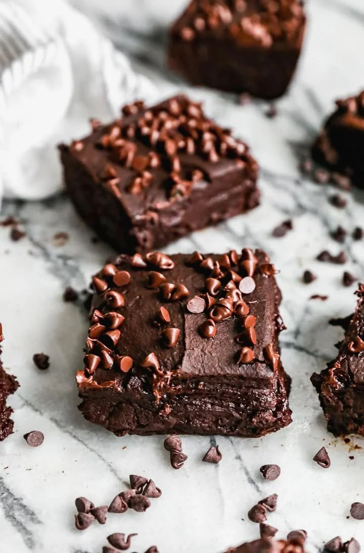 Fudgy black bean brownies served on a plate with chocolate drizzle
