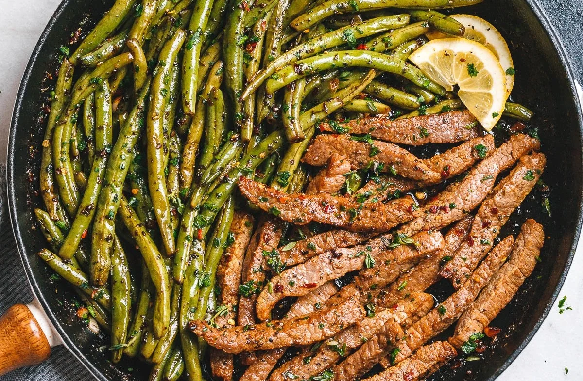Garlic butter steak served with fresh green beans on a plate