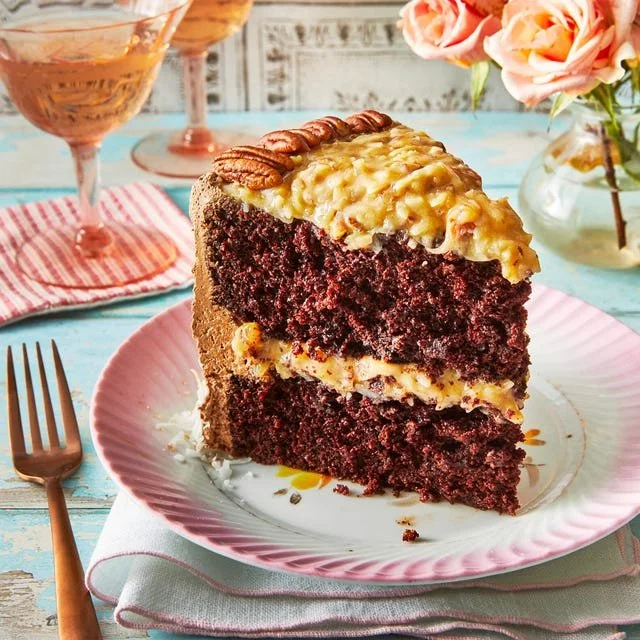 Delicious slice of German Chocolate Cake topped with coconut and pecan frosting