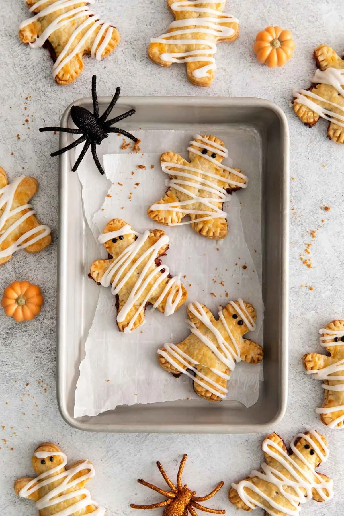 Gluten-free mummy hand pies with a spooky design for Halloween.