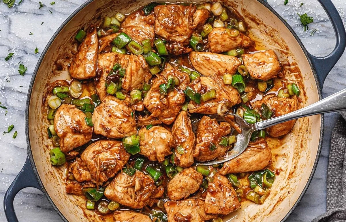 Delicious Green Onion Chicken Stir-Fry served in a bowl with fresh vegetables.