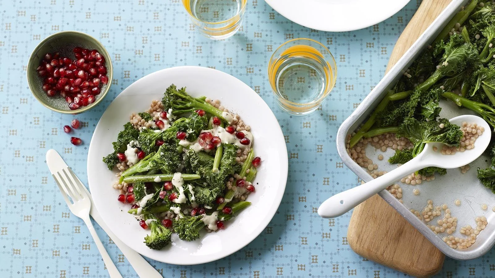 Greens salad featuring giant couscous and tahini dressing