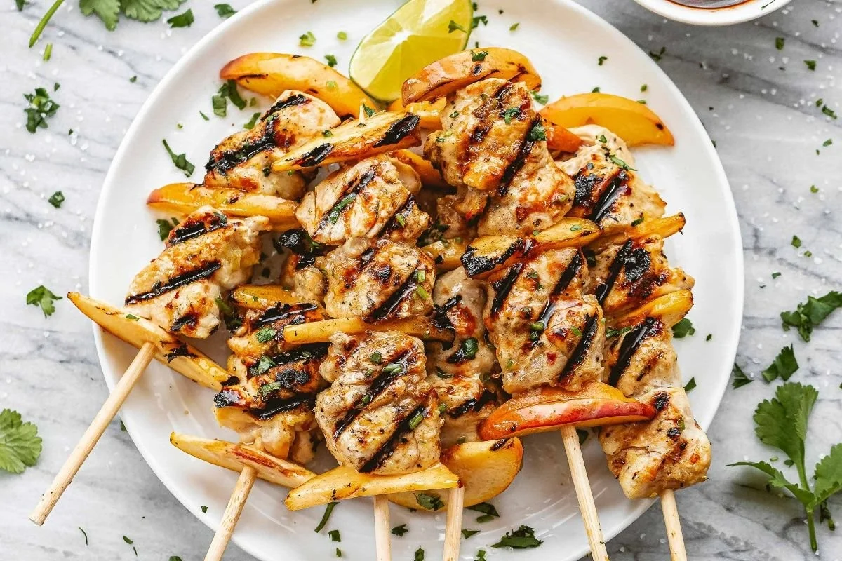Grilled chicken peach kebabs on a skewer with vibrant colors