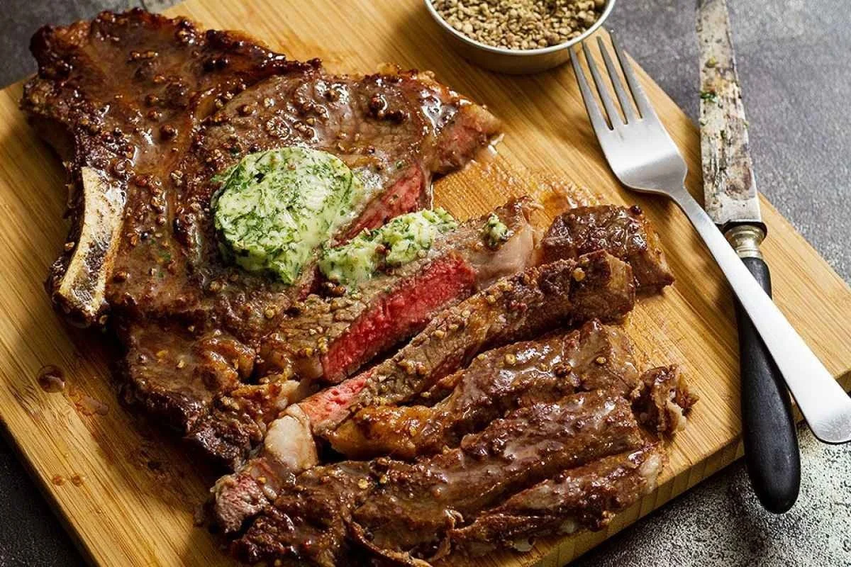 Juicy grilled ribeye steaks served with melting parsley butter.