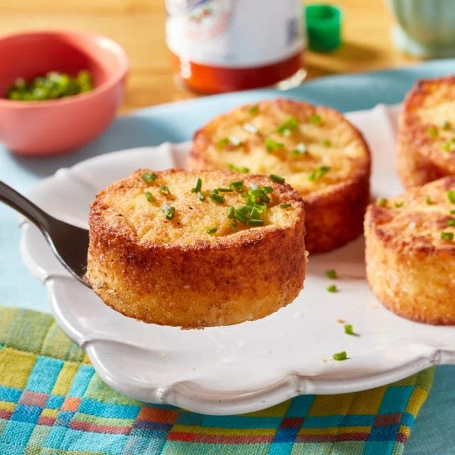 Delicious grit cakes served with toppings like gravy and vegetables.