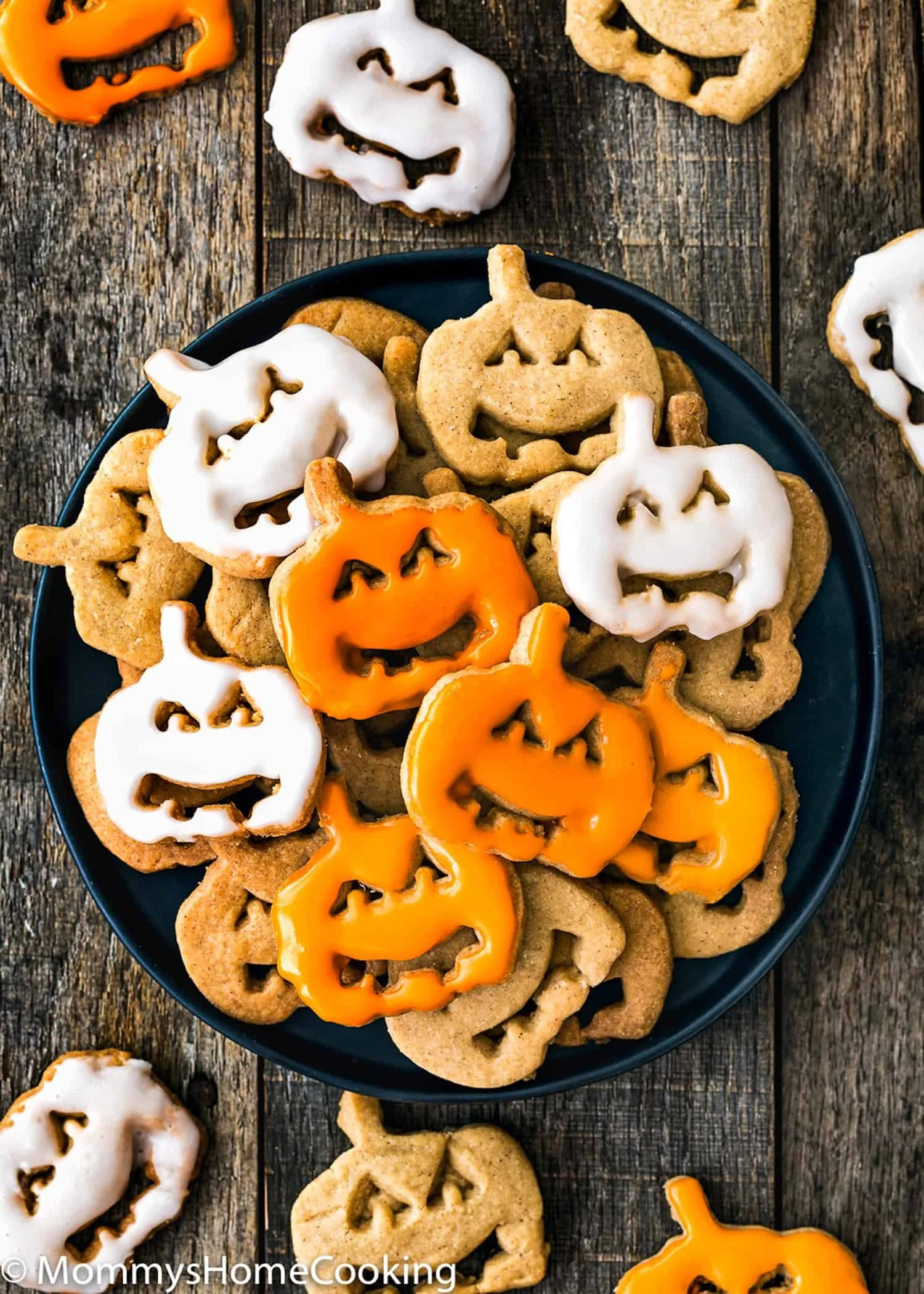 A variety of decorated Halloween cookies in festive shapes and colors.