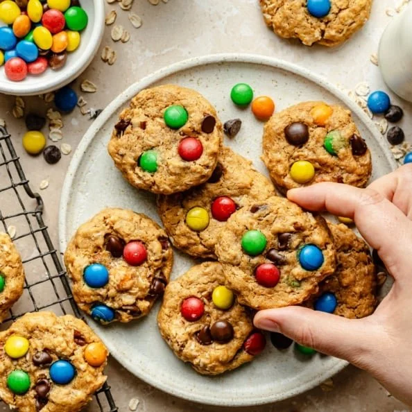 Delicious healthy flourless monster cookies stacked on a plate.