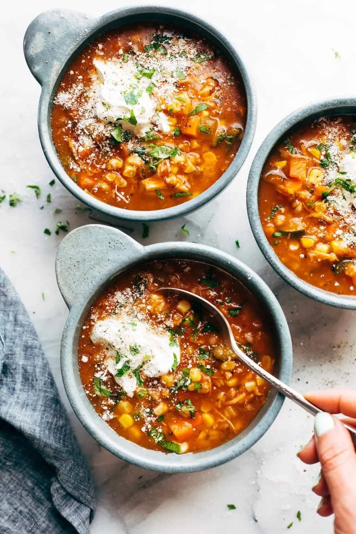 Delicious hearty summer soup with fresh vegetables and herbs