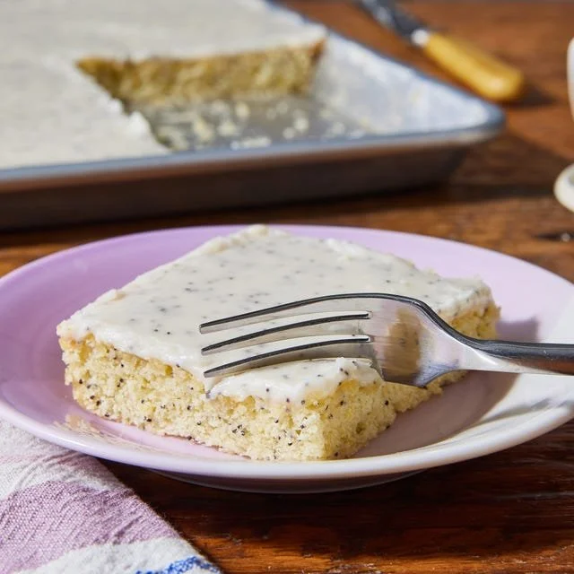 Delicious Lemon Poppy Seed Sheet Cake with frosting and poppy seeds.
