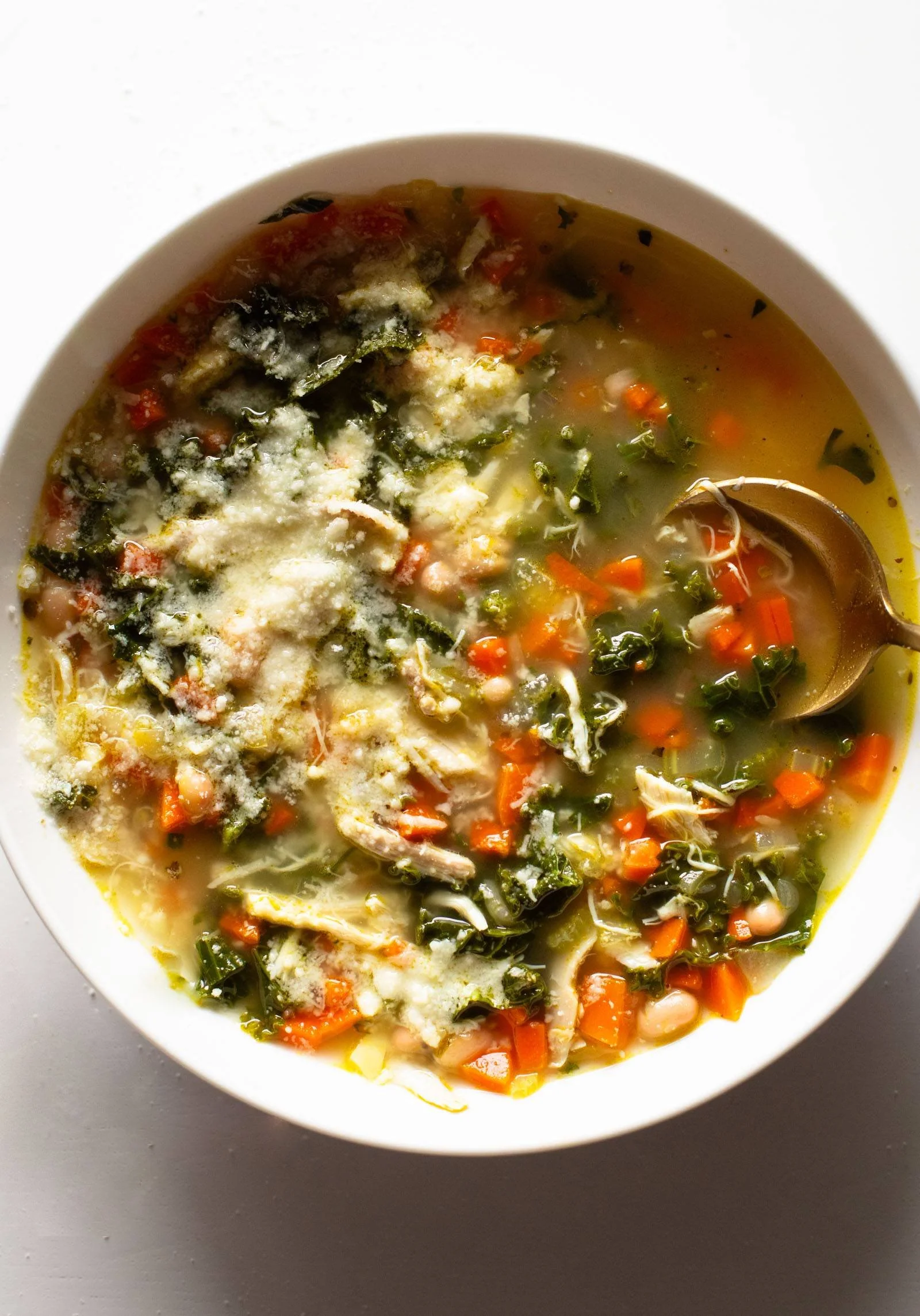 Bowl of Lemon Rosemary Chicken Soup garnished with rosemary sprigs