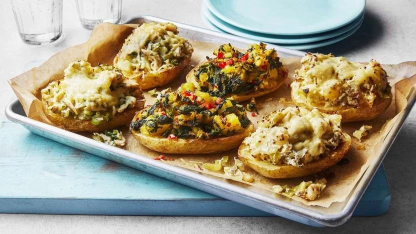 Delicious loaded jacket potatoes topped with cheese, sour cream, and chives.
