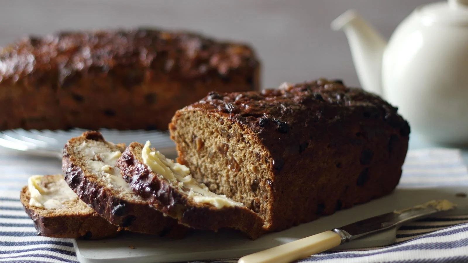 Freshly baked Malt Loaf on a wooden cutting board